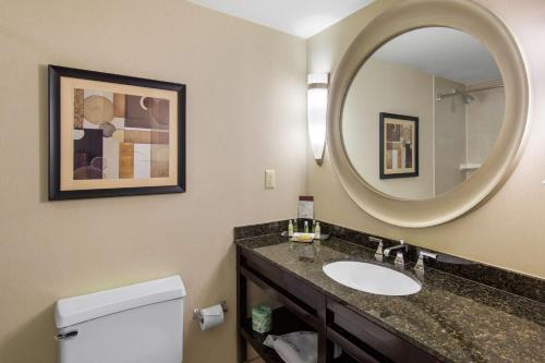 uma casa de banho com um lavatório e um espelho em DoubleTree by Hilton Downtown Wilmington - Legal District em Wilmington