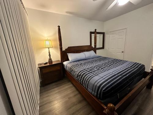 a bedroom with a bed and a table and a lamp at The Avalon in Clearwater