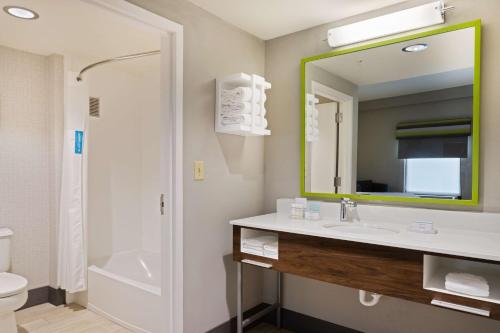 a bathroom with a sink and a mirror at Hampton Inn Jacksonville-I-295 East/Baymeadows in Jacksonville