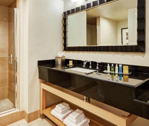 a bathroom with a sink and a mirror at DoubleTree by Hilton Hotel Berkeley Marina in Berkeley