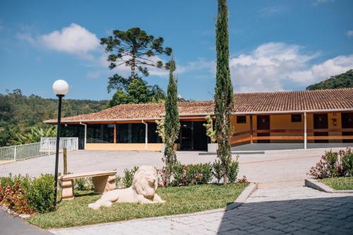 a dog laying in the grass in front of a building at Espaco Villa Verde LTDA in Ibiúna