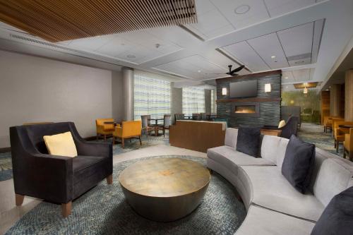 a living room with a couch and chairs and a table at Homewood Suites by Hilton Gaithersburg/Washington, DC North in Gaithersburg