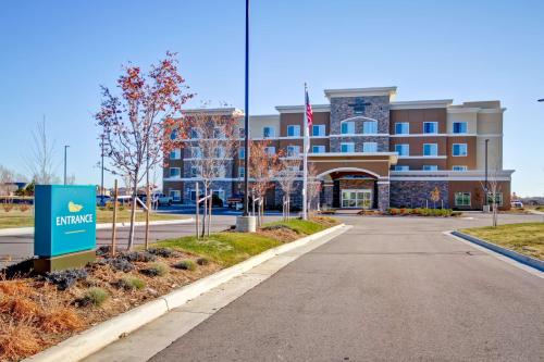 a building with a sign in front of a street at Homewood Suites by Hilton Greeley in Greeley