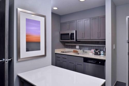 a kitchen with purple cabinets and a white counter top at Homewood Suites by Hilton Trophy Club Southlake in Trophy Club