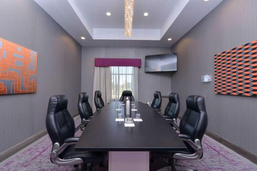 a conference room with a black table and black chairs at Homewood Suites by Hilton Trophy Club Southlake in Trophy Club