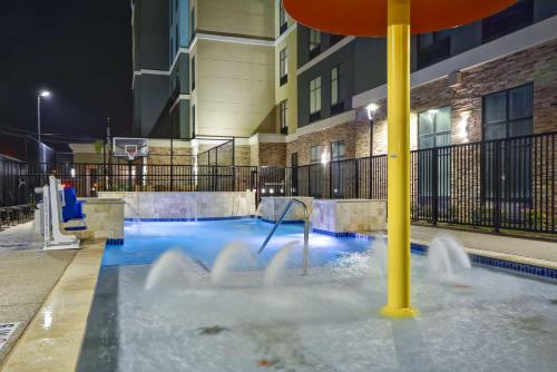 a water slide in a pool in a building at Homewood Suites By Hilton Galveston in Galveston