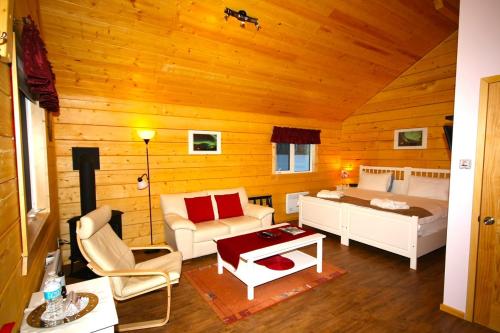 a living room with a bed and a couch at Northern Lights Resort & Spa in Whitehorse