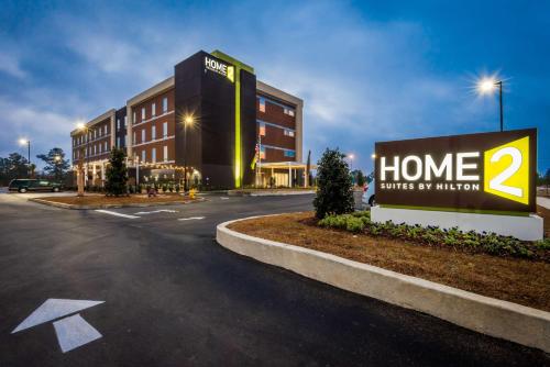 a building with a sign that reads home smiles at autism at Home2 Suites by Hilton Gulfport I-10 in Gulfport