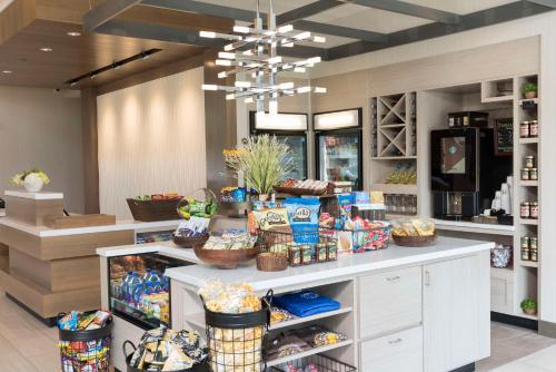 a store with a counter with baskets of food at Hilton Garden Inn Grand Rapids East in Grand Rapids