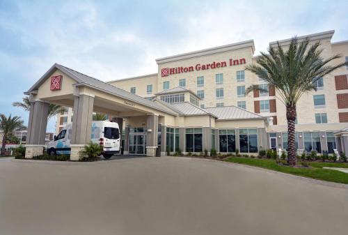 a hotel with a van parked outside of it at Hilton Garden Inn Houston Hobby Airport in Houston