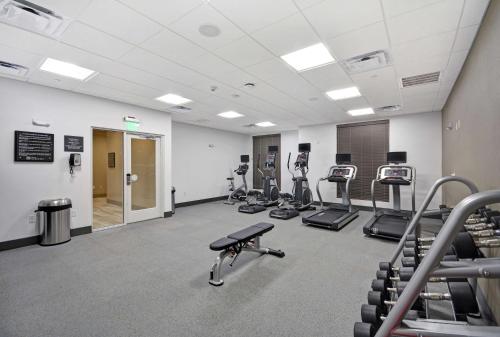 a gym with treadmills and machines in a room at Hilton Garden Inn Houston Hobby Airport in Houston