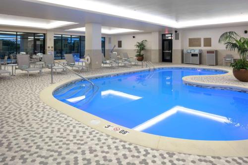 a large swimming pool in a hotel lobby at Embassy Suites By Hilton Grand Rapids Downtown in Grand Rapids