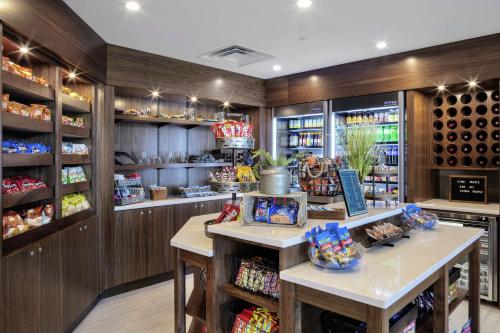 a wine tasting room with a counter and wine bottles at Embassy Suites By Hilton Grand Rapids Downtown in Grand Rapids