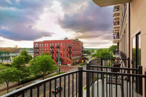 a balcony with a view of a red brick building at Embassy Suites By Hilton Grand Rapids Downtown in Grand Rapids