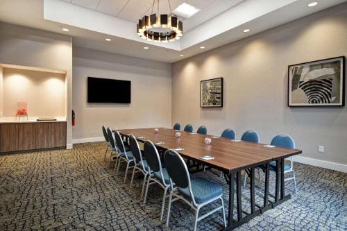 a conference room with a large wooden table and chairs at Homewood Suites By Hilton Greenville Downtown in Greenville