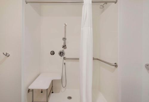 a shower with a white shower curtain in a bathroom at Hampton Inn & Suites D'Iberville Biloxi in Biloxi