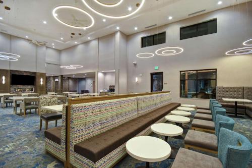 a restaurant with tables and chairs and a bar at Homewood Suites By Hilton Orange New Haven in Orange