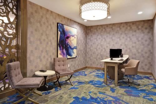 a waiting room with chairs and a desk and a computer at Homewood Suites By Hilton Orange New Haven in Orange