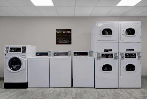 a row of white washing machines in a room at Homewood Suites By Hilton Edison Woodbridge, NJ in Edison