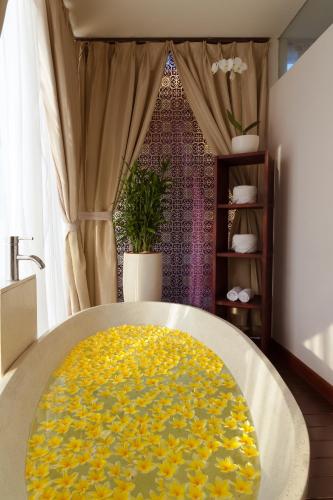 a yellow rug on a table in a room at Grand Seminyak Lifestyle Boutique Bali Resort in Seminyak