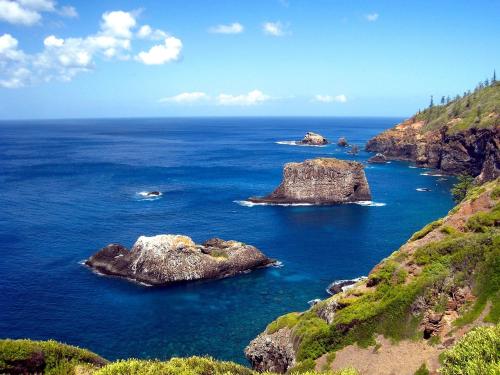 a group of rocks in the ocean on a hill at Saints Apartment - Free unlimited WIFI in Burnt Pine