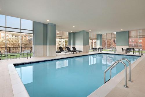 a large swimming pool with blue water in a building at Hampton Inn Indianapolis Downtown IUPUI in Indianapolis