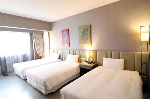 Postel nebo postele na pokoji v ubytování Kaohsiung Ahotel