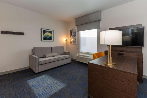 a living room with a couch and a flat screen tv at Hampton Inn & Suites Sugar Land, Tx in Sugar Land