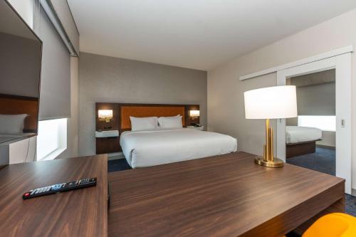 a hotel room with a bed and a table with a lamp at Hampton Inn & Suites Sugar Land, Tx in Sugar Land