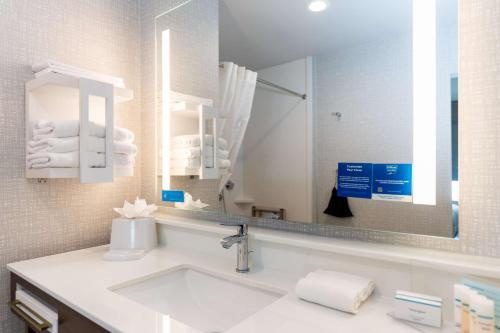 a bathroom with a sink and a large mirror at Hampton Inn & Suites Sugar Land, Tx in Sugar Land