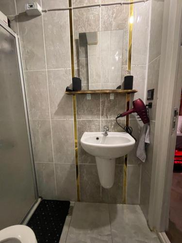 a bathroom with a sink and a shower at Yeniköy KONSEPT HOTEL in Arnavutköy