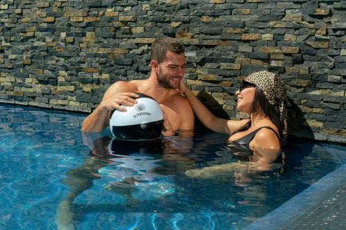 a man and a woman in a swimming pool at Casa Salles Hotel Boutique in Tequila
