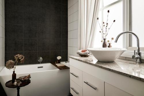 a bathroom with a white sink and a window at Luxury Bendigo Stay in Golden Square