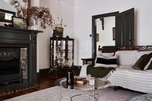 a living room with a couch and a fireplace at Luxury Bendigo Stay in Golden Square