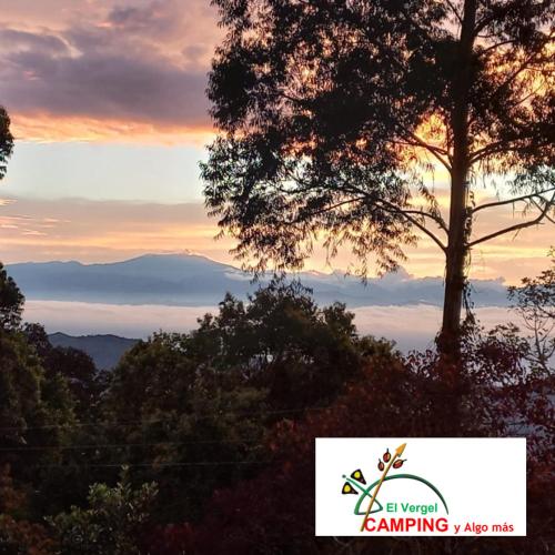 a picture of a sunset with a tree in the foreground at Finca posada del camino real in Guaduas