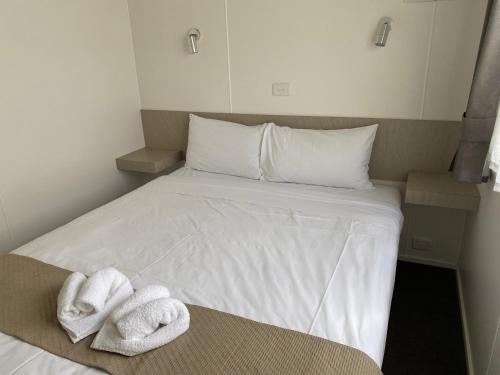 a bed with towels on it in a room at Ingenia Holidays Old Bar Beach in Old Bar