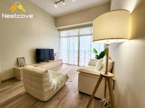 a living room with a couch and a television at Costa Mahkota Suites Malacca Central By Nestcove in Melaka