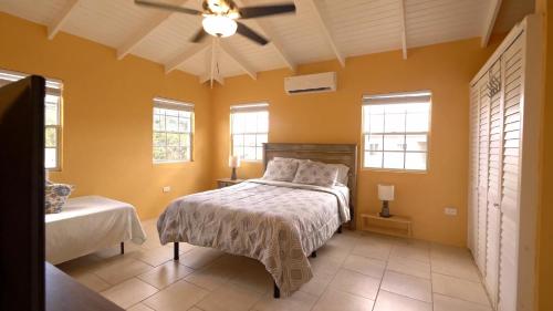 a bedroom with a bed in a room with yellow walls at Royal Palms Estate in Christiansted