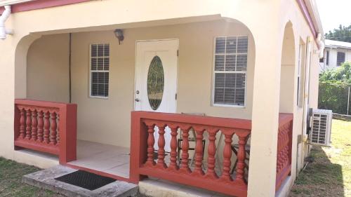 a house with a red and white fence at Royal Palms Estate in Christiansted