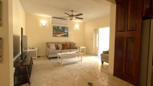 a living room with a couch and a table at Royal Palms Estate in Christiansted