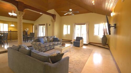 a living room with couches and a ceiling fan at Royal Palms Estate in Christiansted