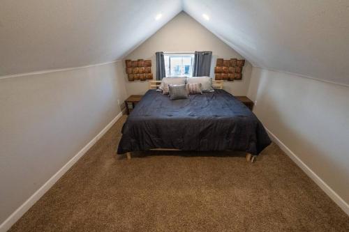 a bedroom with a large bed in a attic at Indy 4-Bedroom Haven: Your Perfect Retreat in Indianapolis