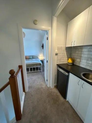 a small kitchen with a sink and a counter at Seaglass Cottage in Lower Hutt