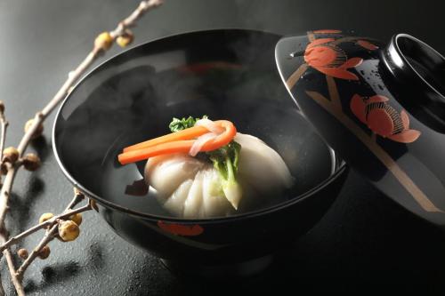 a pan with a carrot on top of food at Gora Kadan in Hakone