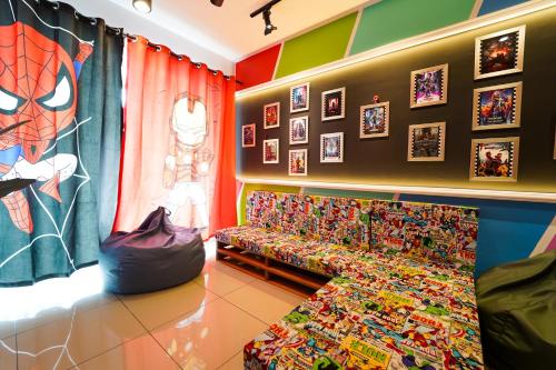 a living room with a couch and pictures on the wall at 家 Majestic Ipoh in Ipoh