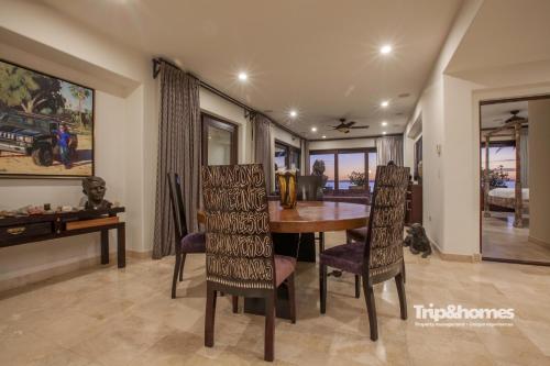 a dining room with a wooden table and chairs at Playa de La Paz 3 BR Condo Access to Beach club in La Paz