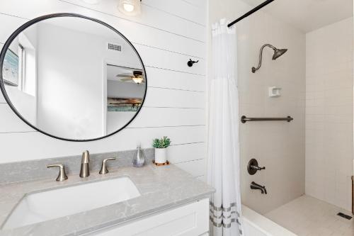 a bathroom with a sink and a mirror at Walk on the Ocean! Wake up to Beautiful Bay Views in Newport Beach