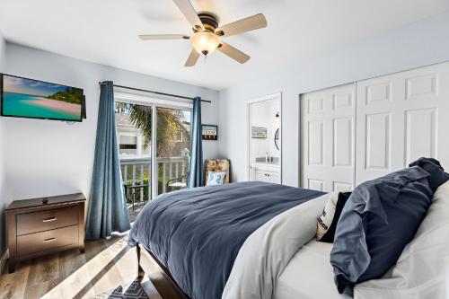 a bedroom with a bed and a ceiling fan at Walk on the Ocean! Wake up to Beautiful Bay Views in Newport Beach