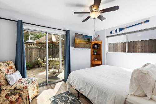 a bedroom with a bed and a ceiling fan at Walk on the Ocean! Wake up to Beautiful Bay Views in Newport Beach
