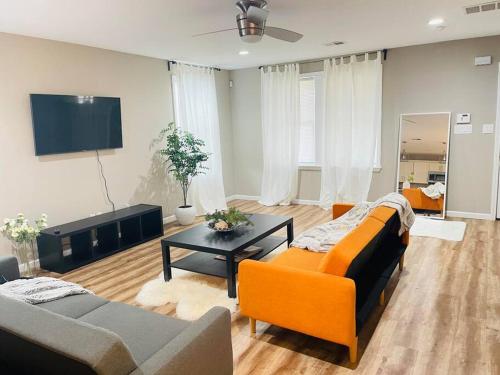 a living room with two couches and a table at Spacious home, 3 king beds, huge backyard near UM in Memphis